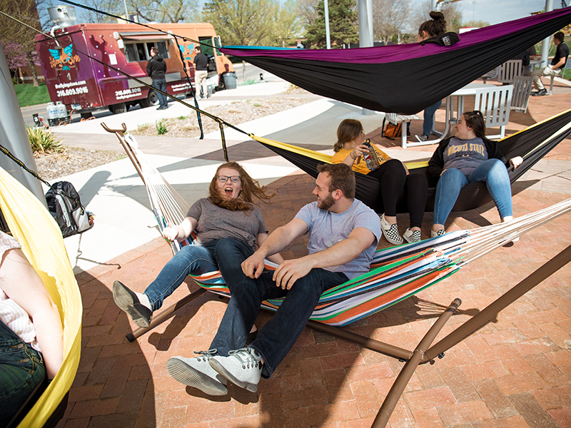 Students in hammocks hanging at the Food Truck Plaza